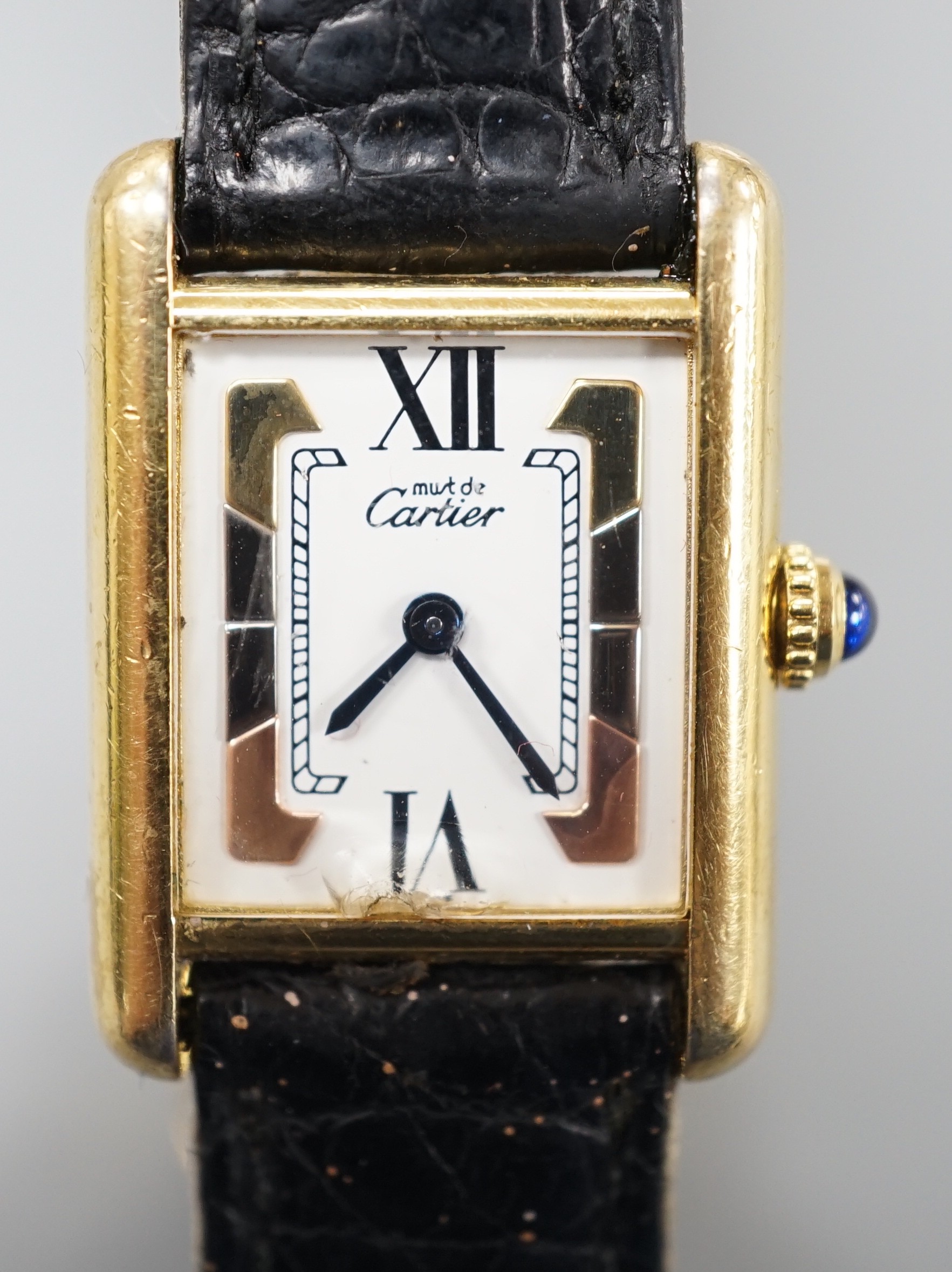 A lady's modern 925 gilt Must de Cartier rectangular quartz wrist watch, with three colour dial, on Cartier bracelet with gilt steel deployment clasp, no box or papers.